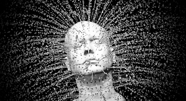 Man's mannequin bursting out into water droplets