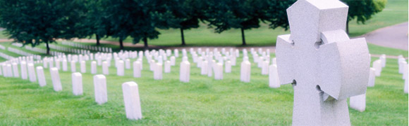Photo of a cemetry, gravestones epitaphs over a green field